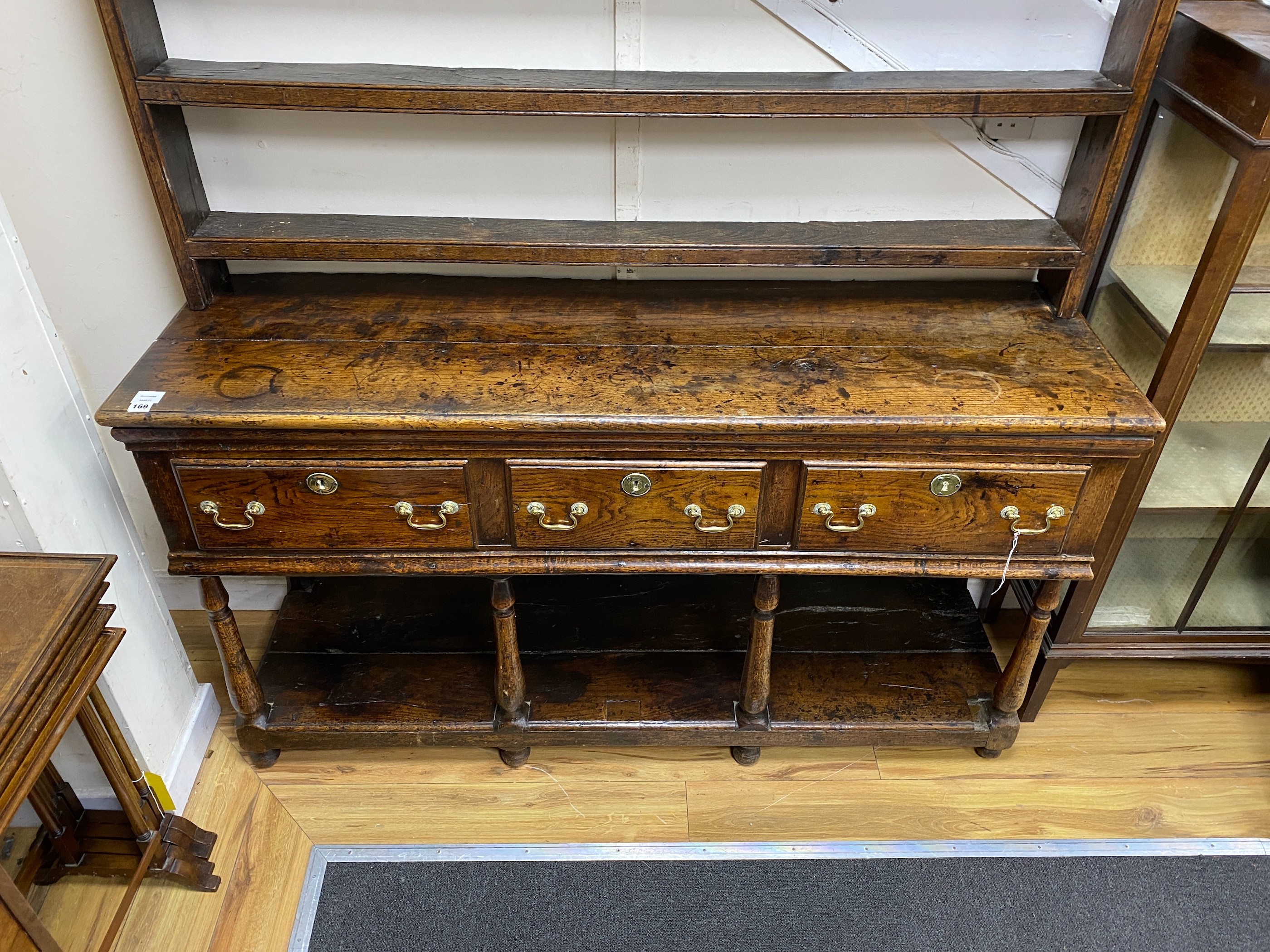 A mid 18th century oak potboard dresser, with an open shelved rack, over four drawers, width 158cm, depth 45cm, height 190cm